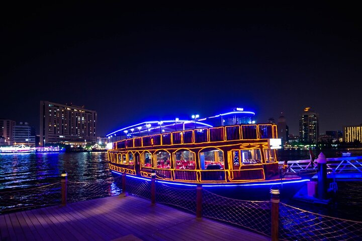 Relish a delightful international buffet dinner while cruising past Dubai's illuminated skyline soaking in stunning views and enjoying lively entertainment under the starry night.